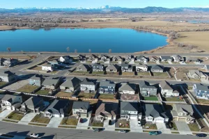 aerial photography taken by Pandion Property Inspections, LLC of new subdivision in Berthoud Colorado with lake and Rocky Mountains in background using a drone
