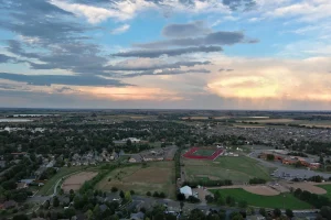 Aerial photo taken by Pandion Property Inspections, LLC of the town of Berthoud looking towards the east at sunset