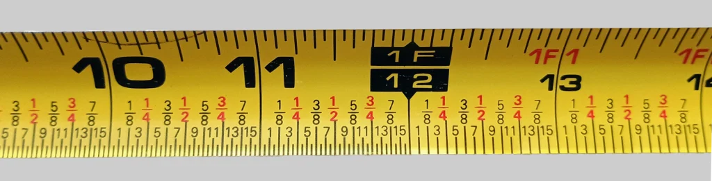 Tape measure showing fractions along one edge.