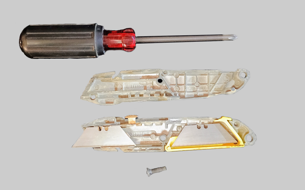 Utility knife that requires a screwdriver to open for exchanging blades