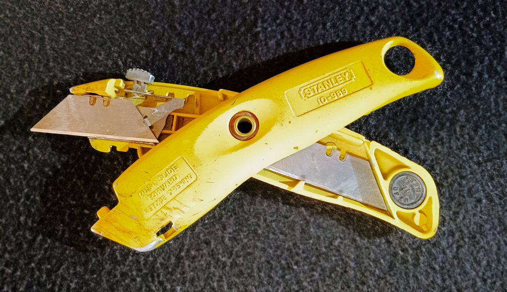 Utility knife with built-in pivot and internal blade storage.